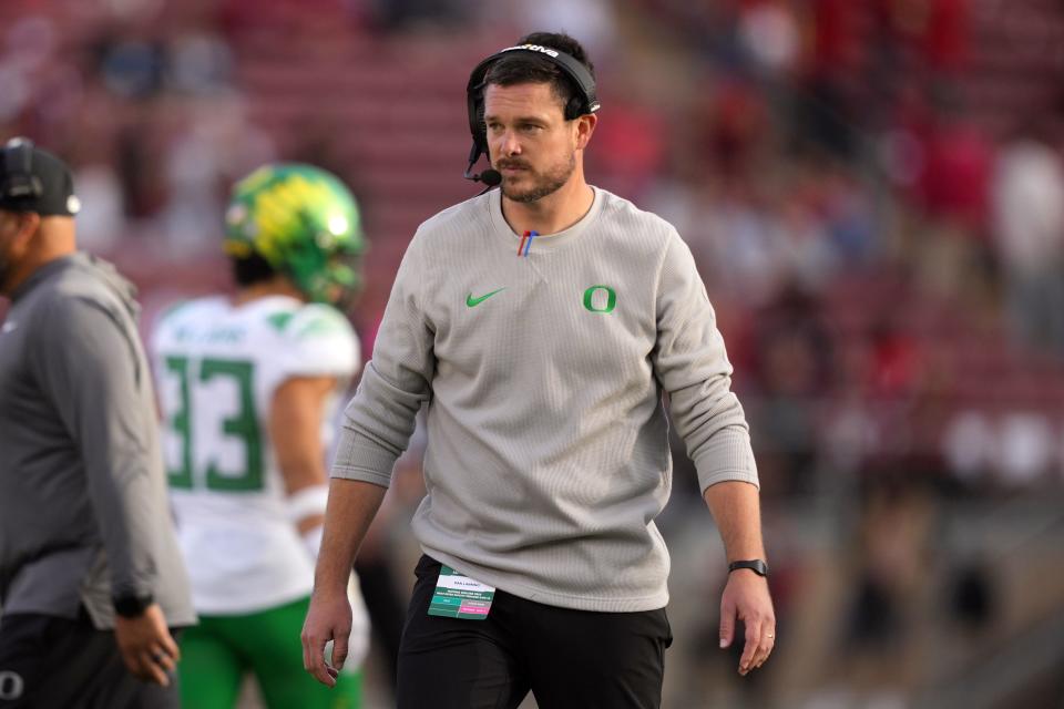 Oregon coach Dan Lanning walks the sideline during his team's game against Stanford at Stanford Stadium.