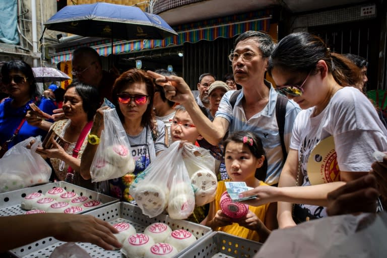 Customers buy traditional buns made for the annual Cheung Chau bun festival in Hong Kong on May 3, 2017