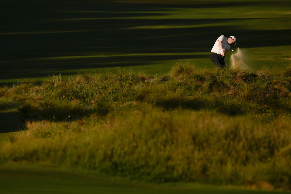 Robert MacIntyre, of Scotland, hits from the native area on the first hole during the second round of the U.S. Open golf tournament Friday, June 14, 2024, in Pinehurst, N.C. (AP Photo/Matt York)