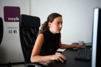 Employee of the non-profit organization "noyb" sits at a desk in Vienna