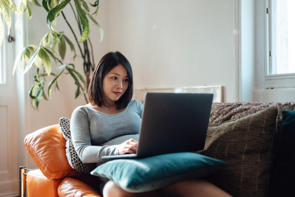 Woman writing from her couch