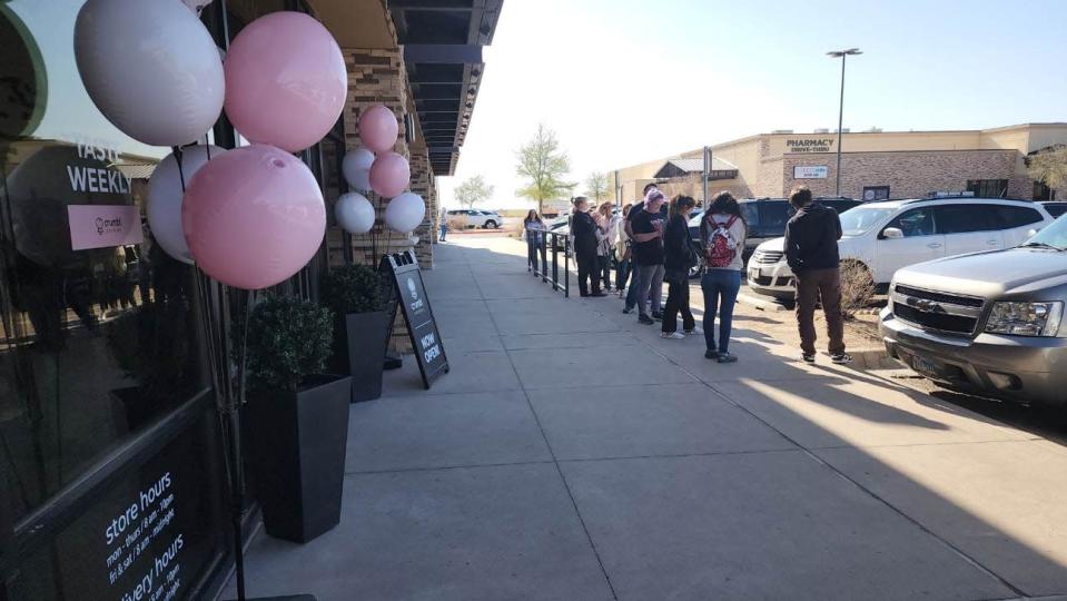 Individuals wait outside of the new Amarillo bakery, Crumbl Cookies, located at 3562 S. Soncy Road Suite 341.