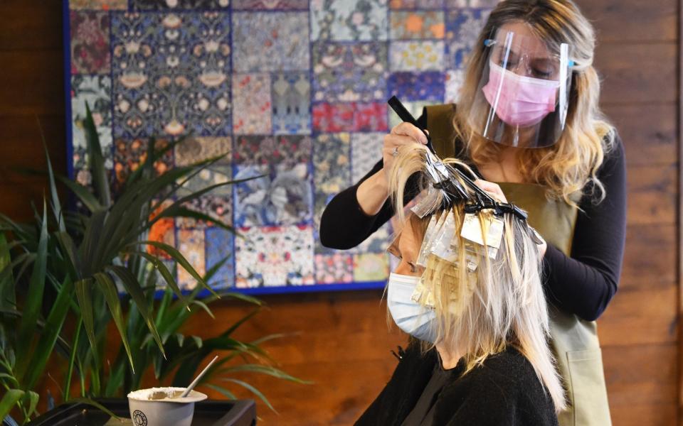 Amanda Sidley, owner of Bronte's Hair Boutique, colors a customers hair after reopening - Nathan Stirk / Getty Images Europe