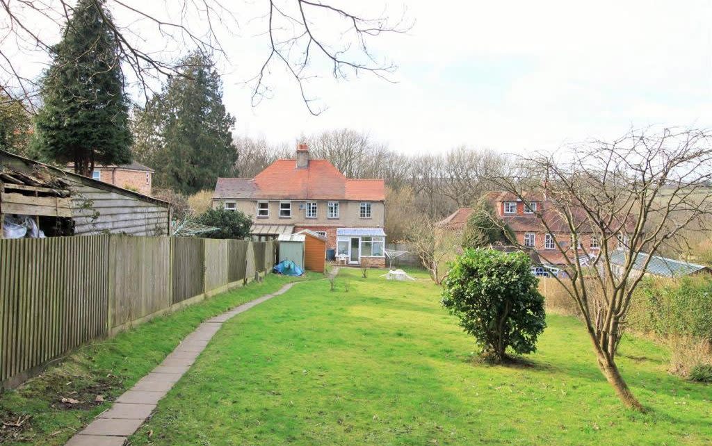 The fence at the centre of the dispute in 2015, dividing the Coates family property on the right from their neighbours on the left