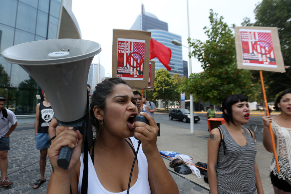 Demonstrators protest against the inauguration of new US President Donald Trump outside the US embassy in Santiago, on January 21, 2017. The protests in Chile were organised to show solidarity with those marching in Washington DC and around the world in defense of women's rights and human rights.&nbsp;