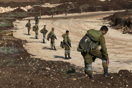 FILE PHOTO: Israeli soldiers search for remains of rockets fired from Lebanon on Sunday, in an open area near the northern city of Nahariya December 21, 2015. REUTERS/Baz Ratner/File Photo