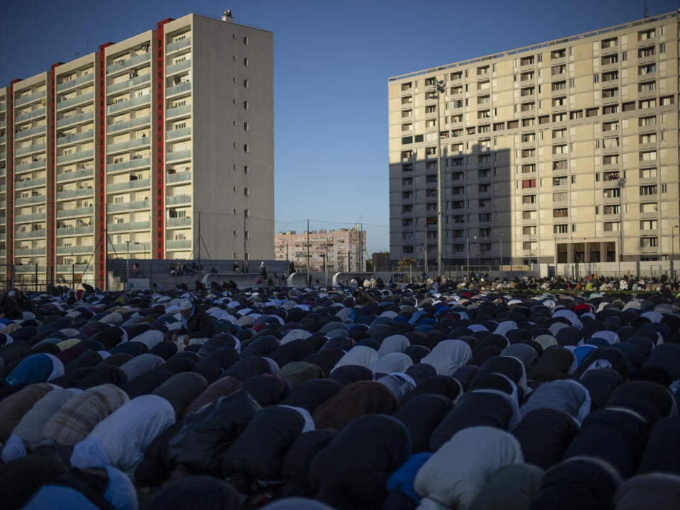 Muslim worshippers offer Eid al-Fitr prayers marking the end of the holy fasting month of Ramadan at the Malpasse soccer stadium in Marseille, southern France, Wednesday, April 10, 2024. (AP Photo/Daniel Cole)