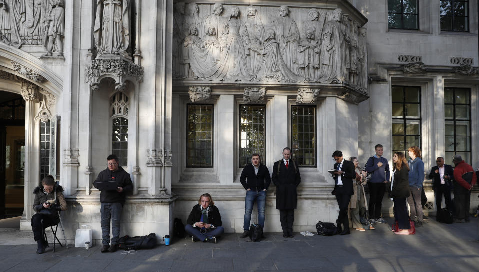 Members of the public queue up for a seat at The Supreme Court in London, Thursday, Sept. 19, 2019. The Supreme Court is set to decide whether Prime Minister Boris Johnson broke the law when he suspended Parliament on Sept. 9, sending lawmakers home until Oct. 14 — just over two weeks before the U.K. is due to leave the European Union. (AP Photo/Alastair Grant)