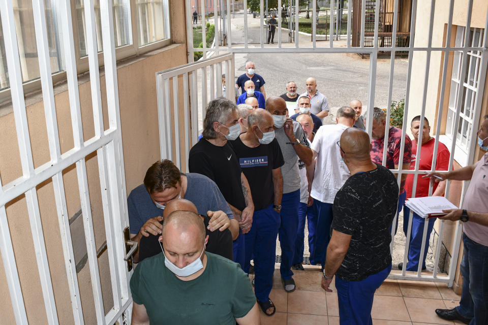 In this image released by Bosnia's Prison Administration inmates wait to get a COVID-19 vaccine at a prison in Zenica, Bosnia, Wednesday, Aug. 18, 2021. While Bosnia remains a laggard of Europe in coronavirus vaccinations, the people serving prison time in the Balkan country's correctional facilities have somewhat surprisingly emerged as its vaccine champions with over 80 percent of inmates in Bosnia's 13 prisons having received at least one Covid-19 vaccine dose.(Bosnian Prison Administration via AP)