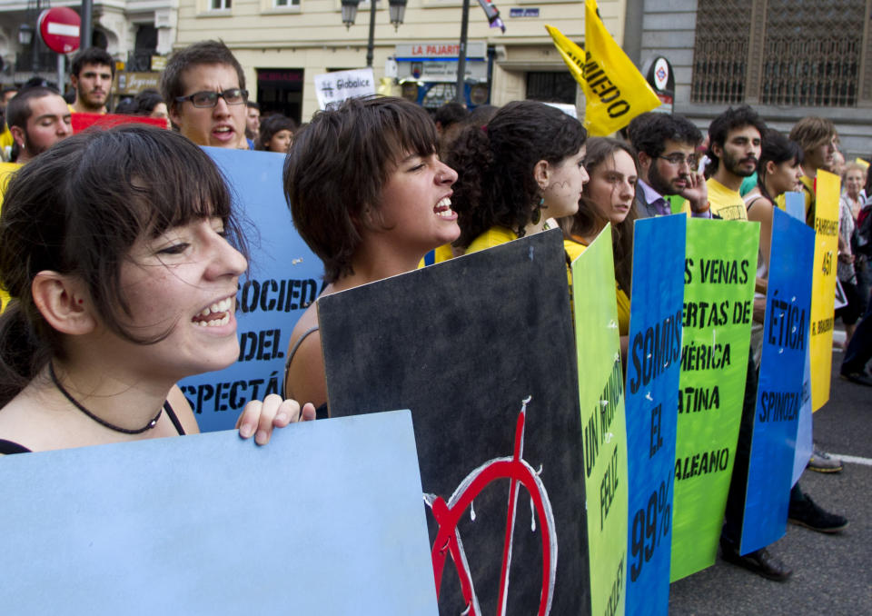 Demonstrators march towards Puerta del Sol plaza in central Madrid Saturday May 12, 2012. Demonstrators arrived in Sol from four different directions as protesters returned to Sol to mark the anniversary of the protest movement that inspired groups in other countries. The protests began May 15 last year and drew hundreds and thousands of people calling themselves the indignant movement. The demonstrations spread across Spain and Europe as anti-austerity sentiment grew. (AP Photo/Paul White)