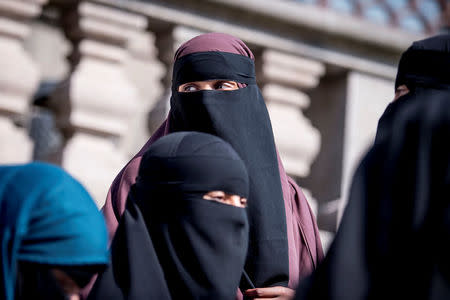 Women in niqab exit the audience seats after the Danish Parliament banned the wearing of face veils in public, at Christiansborg Palace in Copenhagen, Denmark, May 31, 2018. Ritzau Scanpix/Mads Claus Rasmussen/via REUTERS