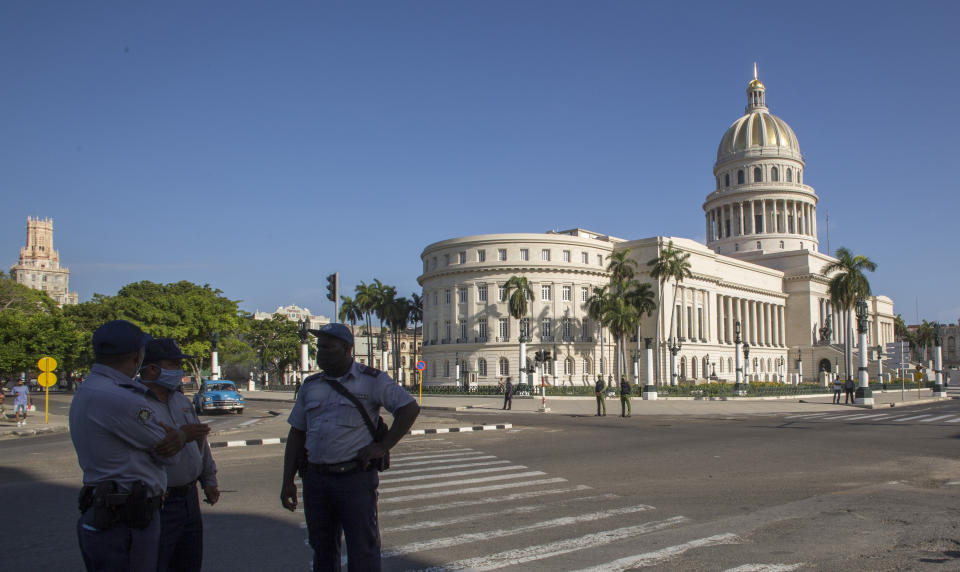 Police stand guard near the National Capitol building in Havana, Cuba, Monday, July 12, 2021, the day after protests against food shortages and high prices amid the coronavirus crisis. (AP Photo/Ismael Francisco)