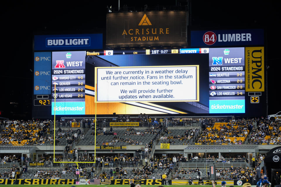 A message is seen on a large screen during a weather delay prior to an NFL football game between the Pittsburgh Steelers and the Dallas Cowboys, Sunday, Oct. 6, 2024, in Pittsburgh. (AP Photo/Gene J. Puskar)