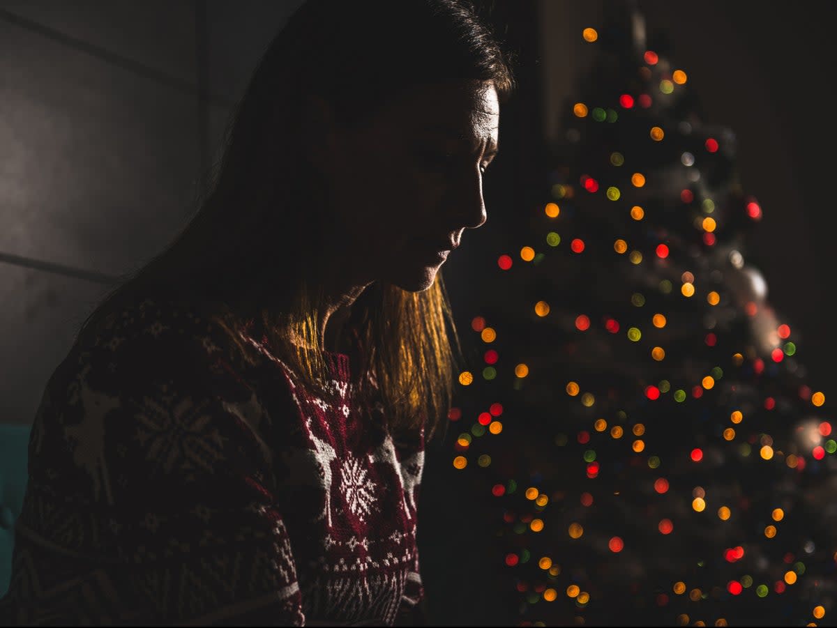 A woman sits alone on Christmas Day (Getty Images/iStockphoto)