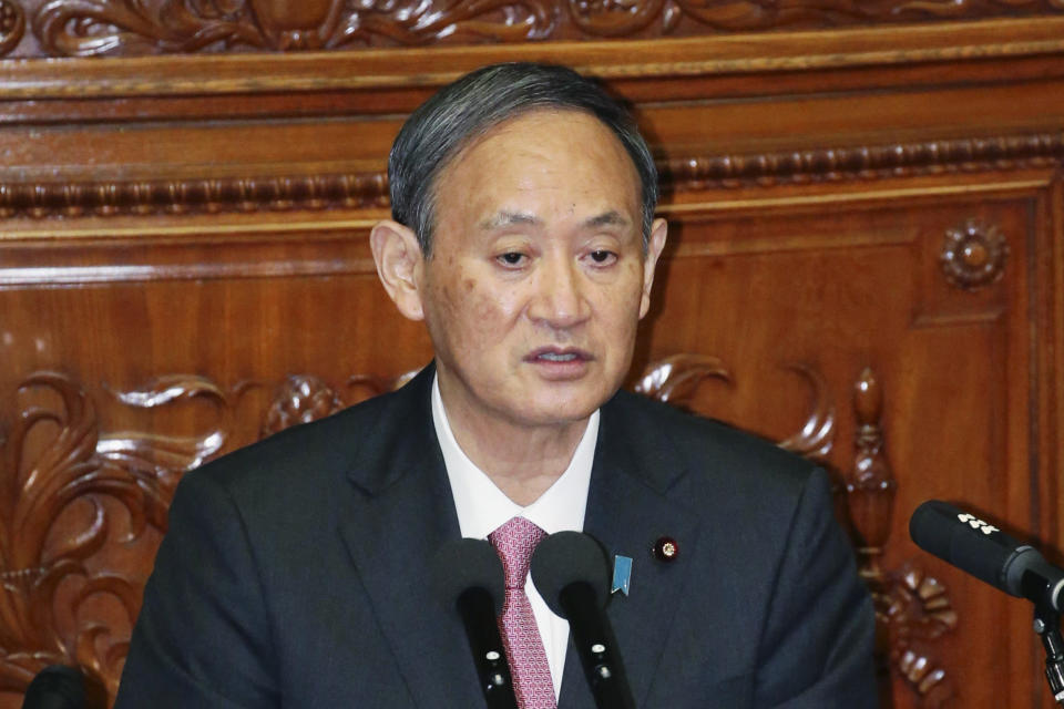 Japanese Prime Minister Yoshihide Suga speaks during a parliamentary session in Tokyo on Wednesday, Oct. 28, 2020. Suga said Wednesday that his government is carefully working on final details on a release of the massive amount of treated but still radioactive water from the wrecked Fukushima nuclear plant, after a speculated decision of a release to the sea by the end of October has triggered fierce protests from fishermen around the country. (Toshiyuki Matsumoto/Kyodo News via AP)