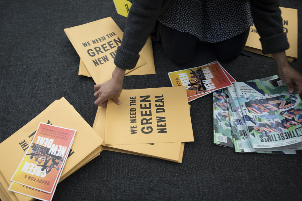 A volunteer prepares information packets for a Green New Deal event at Howard University on May 13. (Photo: AP/Cliff Owen)