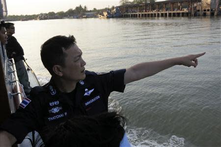 Police Major General Thatchai Pitaneelaboot points to a pier where a Rohingya trafficking victim was brought ashore in Satun, southern Thailand March 27, 2014. REUTERS/Andrew RC Marshall