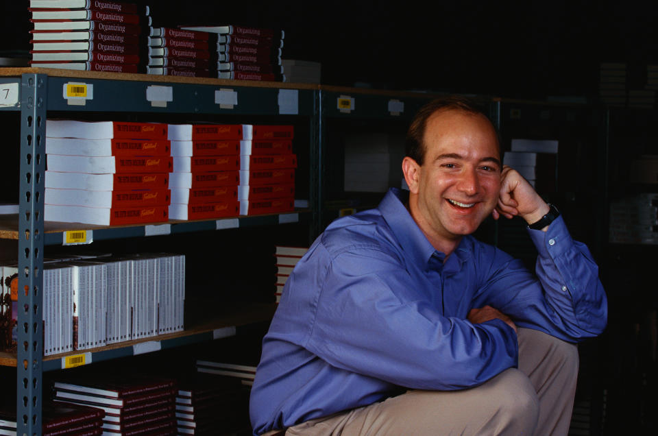 Amazon.com's CEO Jeff Bezos Next to Bookshelves