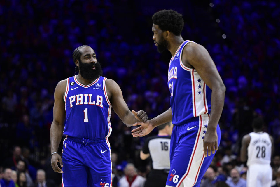 Philadelphia 76ers' James Harden, left, slaps hands with Joel Embiid in the first half during Game 2 in the first round of the NBA basketball playoffs against the Brooklyn Nets, Monday, April 17, 2023, in Philadelphia. (AP Photo/Derik Hamilton)