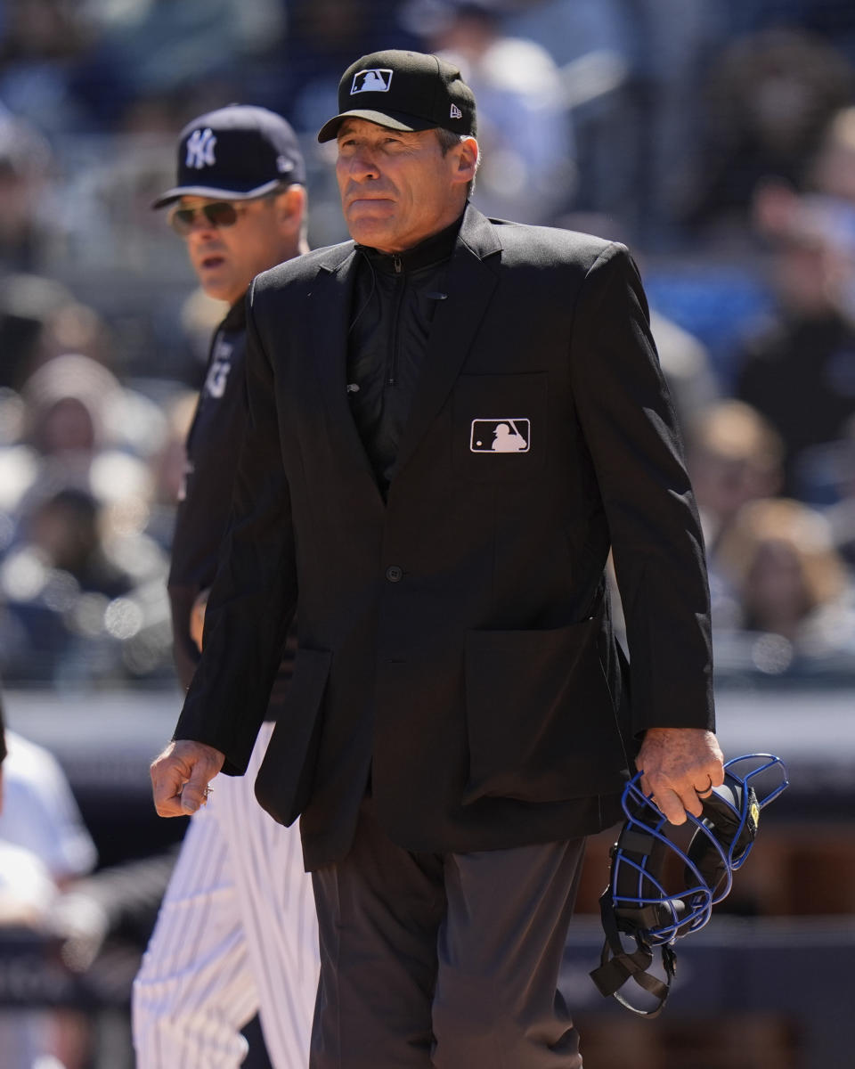 Home plate umpire Angel Hernandez looks away from New York Yankees manager Aaron Boone after a discussion about a call during the first inning of a baseball game against the Toronto Blue Jays Sunday, April 7, 2024, in New York. The Yankees won 8-3. (AP Photo/Frank Franklin II)