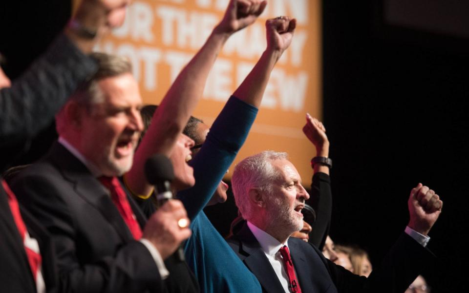 Before: Then-leader Jeremy Corbyn led activists in a rousing rendition of 'The Red Flag' after his conference speech in 2018 - Stefan Rousseau/PA Wire