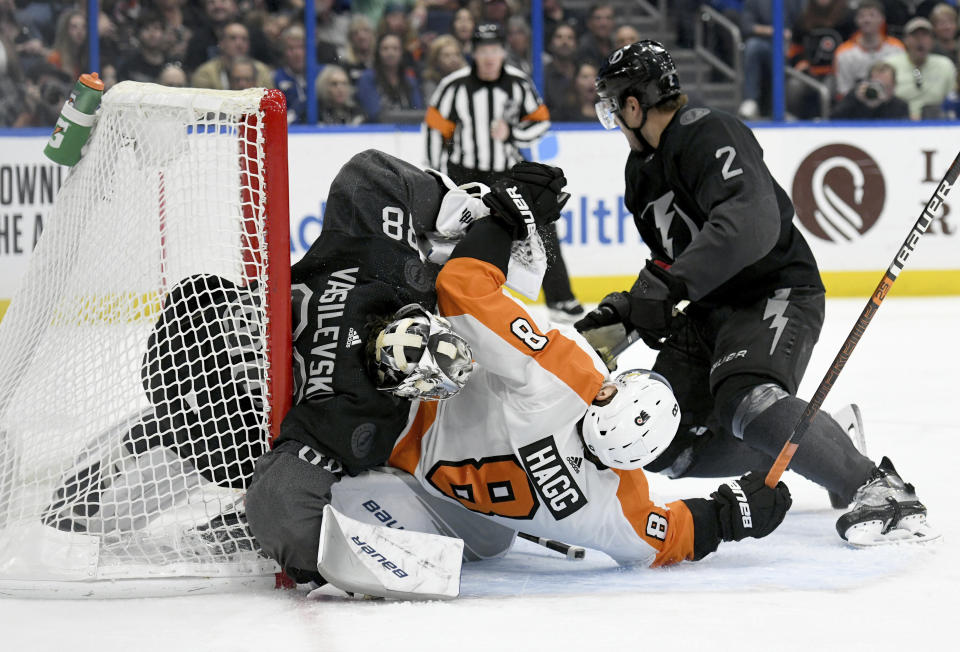 Philadelphia Flyers defenseman Robert Hagg (8) collides with Tampa Bay Lightning goaltender Andrei Vasilevskiy (88) during the third period of an NHL hockey game Saturday, Feb. 15, 2020, in Tampa, Fla. (AP Photo/Jason Behnken)