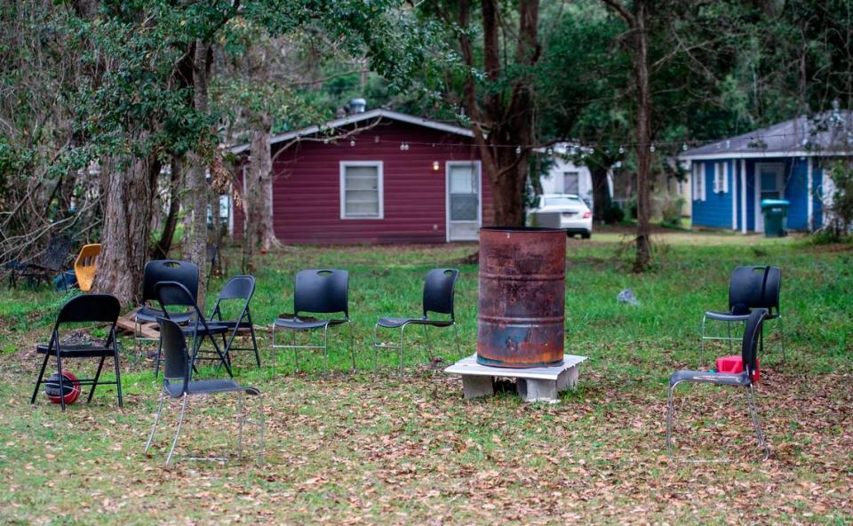 Chairs sit around a makeshift fire pit from a party on a property on Lewis Avenue in the Gaston Point community in Gulfport, the site of a New Years’ Eve shooting that killed three, on Saturday, Jan. 1, 2021.