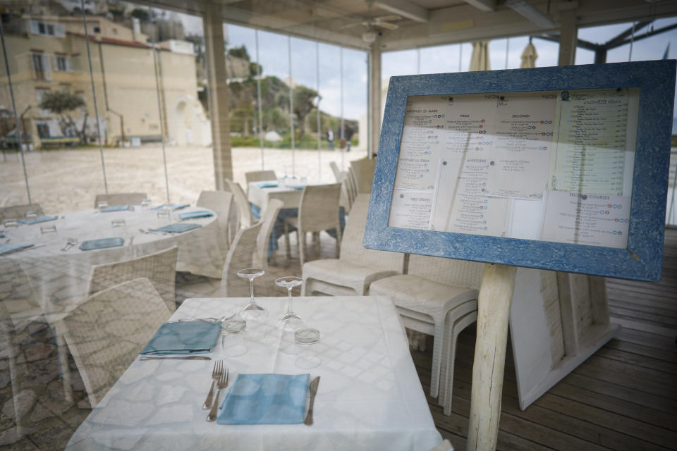 In this photo taken on Tuesday, April 28, 2020, tables are set in a closed restaurant in Sperlonga, a fashionable seaside town about 120km (80 miles) south of Rome. Normally, at this time of year Sperlonga would already be bustling with its first clients of the season. (AP Photo/Andrew Medichini)