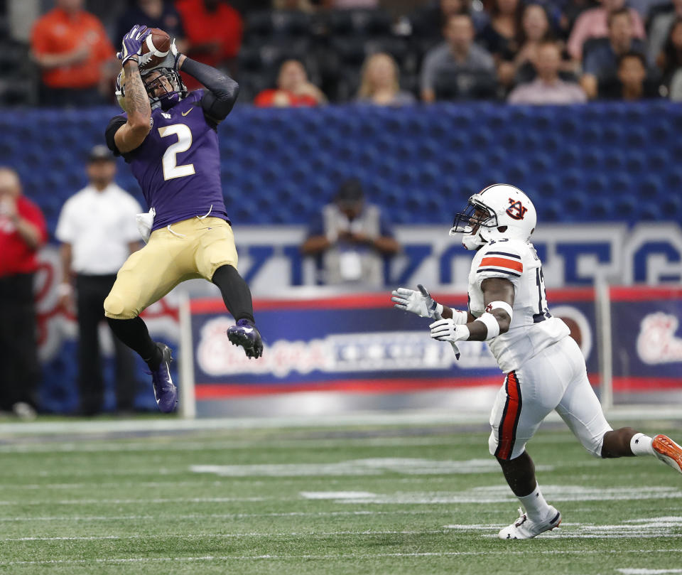 Washington wide receiver Aaron Fuller (2) makes a catch as Auburn defensive back Javaris Davis (13) defends in the first half of an NCAA college football game Saturday, Sept. 1, 2018, in Atlanta. (AP Photo/John Bazemore)