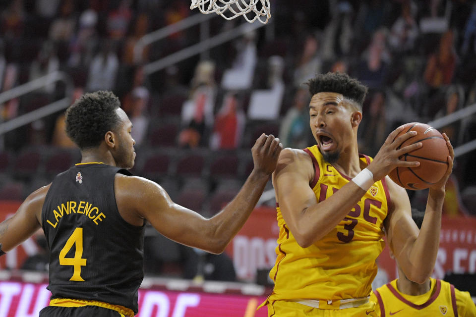 Southern California forward Isaiah Mobley, right, grabs a rebound away form Arizona State forward Kimani Lawrence during the first half of an NCAA college basketball game Wednesday, Feb. 17, 2021, in Los Angeles. (AP Photo/Mark J. Terrill)