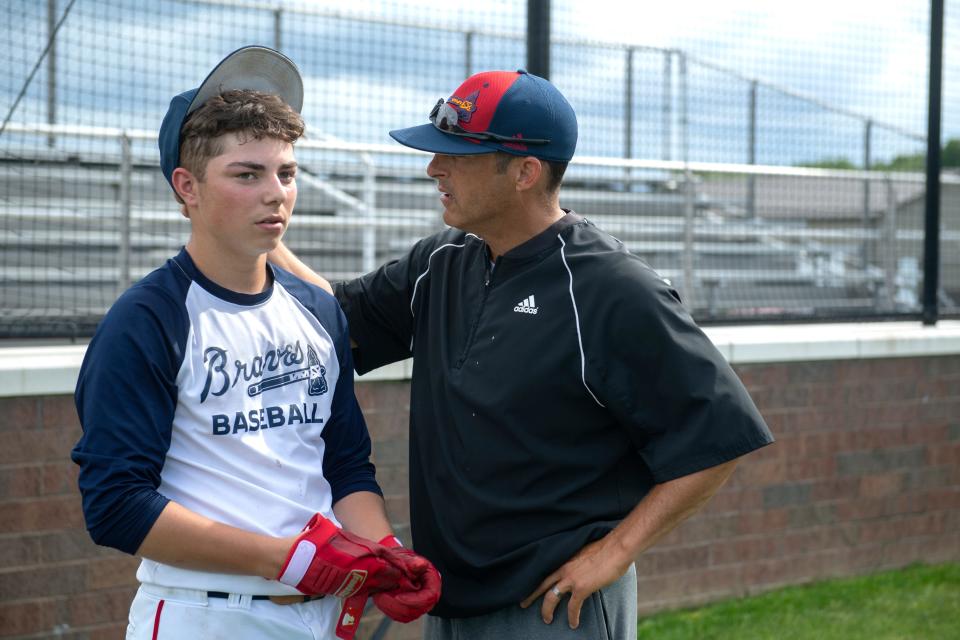 Tecumseh Head Coach Ted Thompson gives a pep talk to freshman Mason Gogel after his batting practice performance Wednesday evening, June 8, 2022. The team is making their first semi-state appearance since 2019, and haven’t won a semi-state title since 2010.