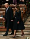 <p>The new First Lady was sombre in a longline belted black coat and patent stilettos. <i>[Photo: Getty]</i> </p>