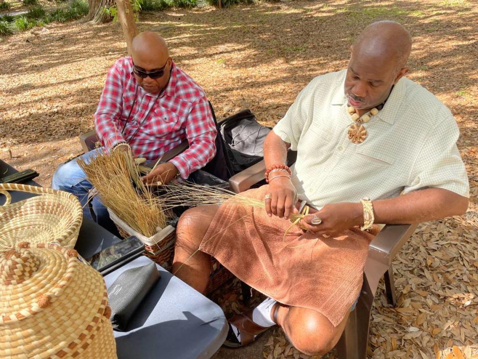 Sweetgrass basket artisans, Michael Smalls and Dino Badger, sell and sew baskets in front of the Coastal Discovery Museum on a spring morning. 