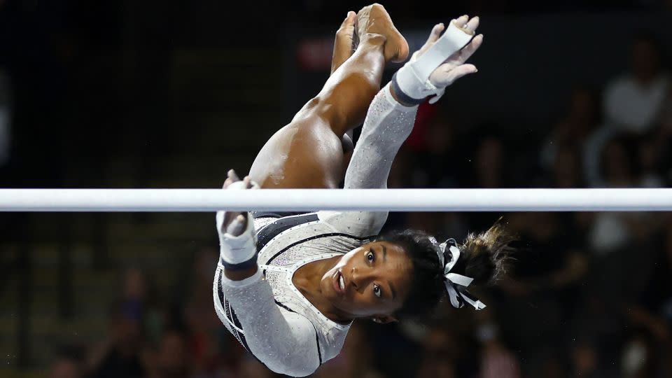 Simone Biles competes in the uneven bars during the Core Hydration Classic. - Stacy Revere/Getty Images