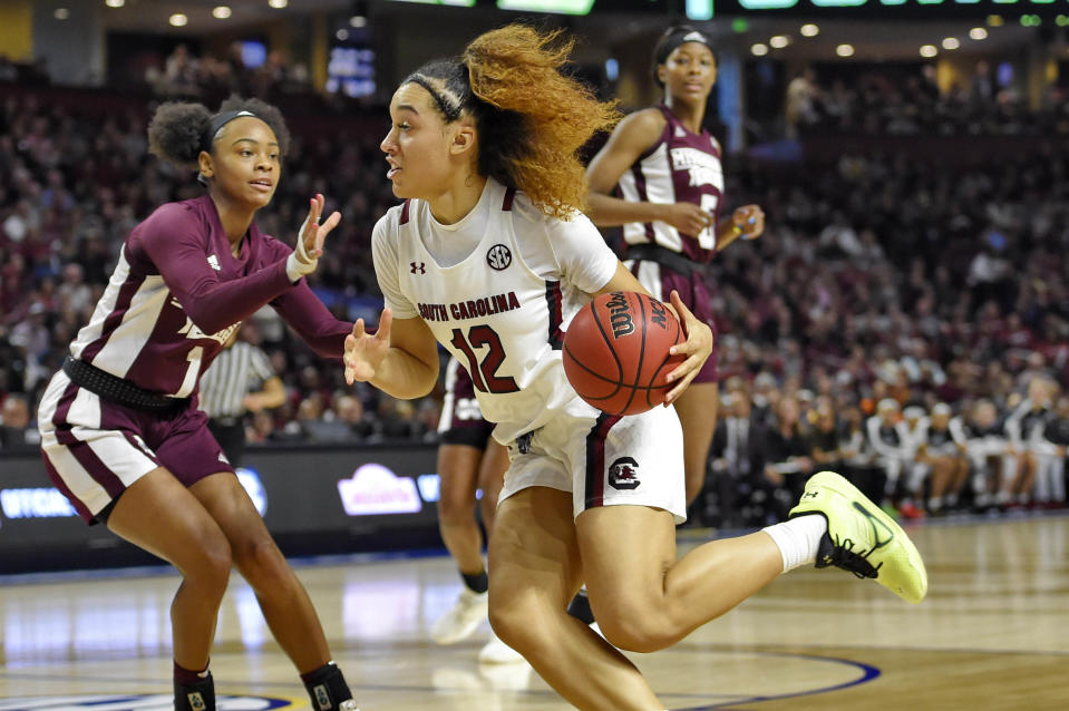 South Carolina's Brea Beal (12) drives while defended by Mississippi State's Myah Taylor (1) during a championship match at the Southeastern Conference women's NCAA college basketball tournament in Greenville, S.C., Sunday, March 8, 2020. (AP Photo/Richard Shiro)