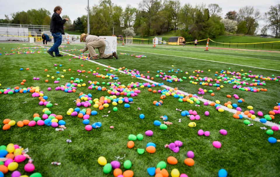 Terry Berry, left, and Tracey Dallas help distribute some of the 12,000 eggs for the 72nd annual West Side Nut Club Easter Egg Hunt Saturday, April 20, 2019.