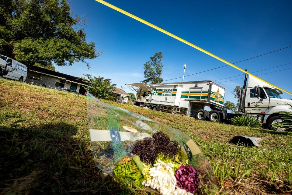 A bouquet of flowers outside a home on North Socrum Loop Road in Lakeland, just days after four members of a family were killed in a predawn home invasion.