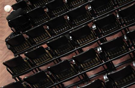 A man sits in the reopened large concert hall of the Liszt Academy music school in Budapest October 21, 2013. REUTERS/Laszlo Balogh