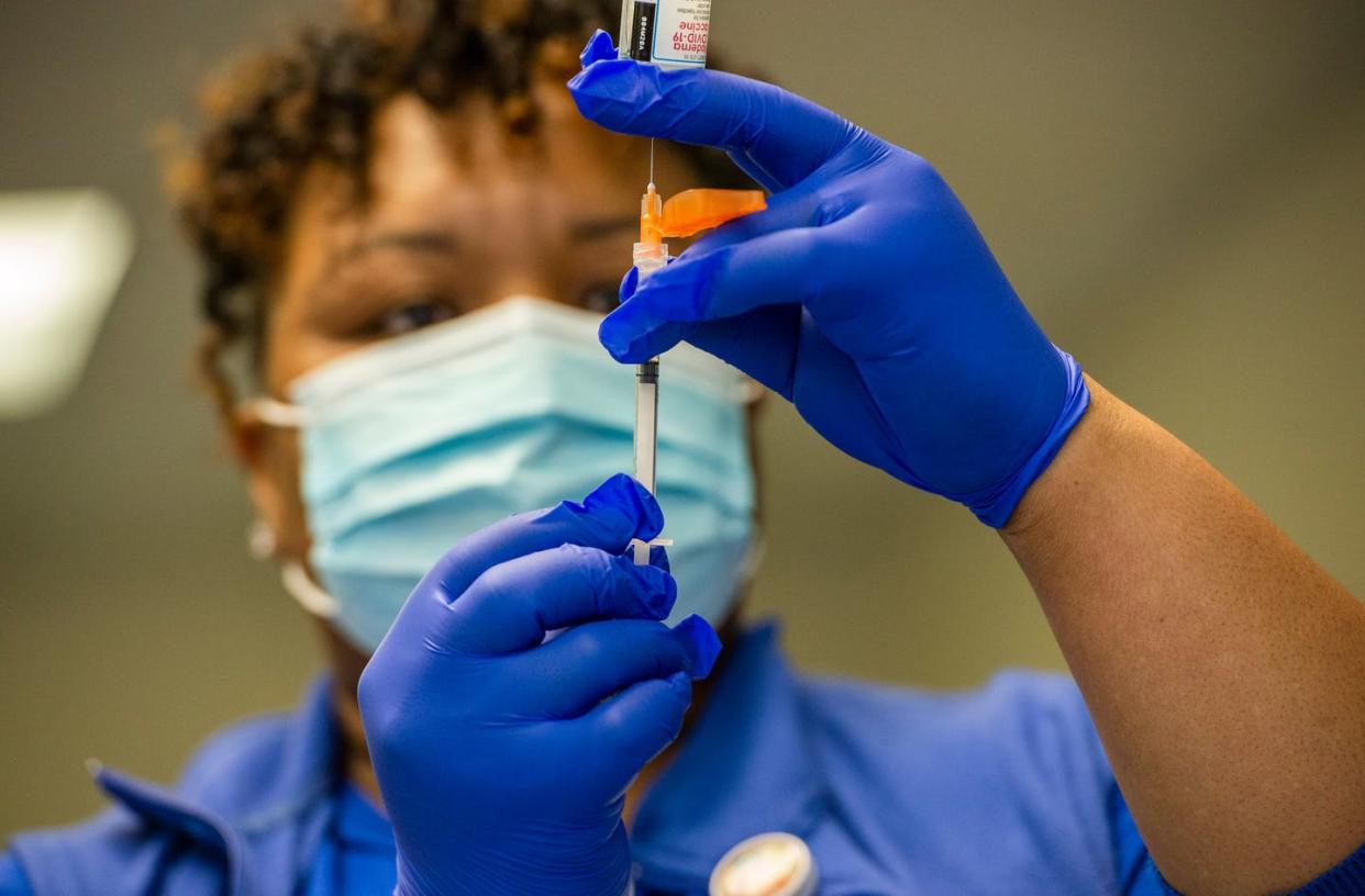 <span class="caption">Nurse Natalie O'Connor loads syringes with the Moderna COVID-19 vaccine in February 2021.</span> <span class="attribution"><a class="link " href="https://www.gettyimages.com/detail/news-photo/natalie-oconnor-loads-syringes-with-the-moderna-covid-19-news-photo/1231125089?adppopup=true" rel="nofollow noopener" target="_blank" data-ylk="slk:Joseph Prezioso/AFP via Getty Images;elm:context_link;itc:0;sec:content-canvas">Joseph Prezioso/AFP via Getty Images</a></span>