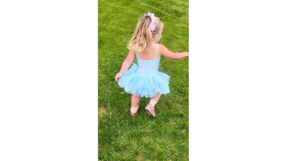 A photo of Romy Johnson wearing a blue tutu