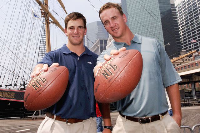 <p>Jemal Countess/Getty</p> Eli Manning and Peyton Manning in 2005