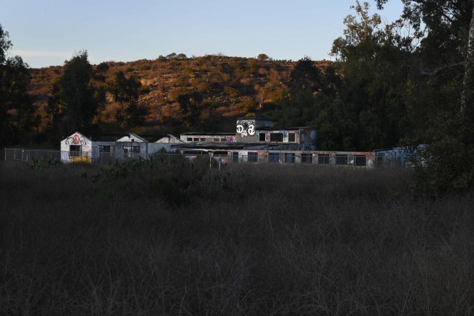 A fence surrounds deteriorated structures at Scary Dairy, the site of a former dairy farm at what's now CSU Channel Islands University Park.