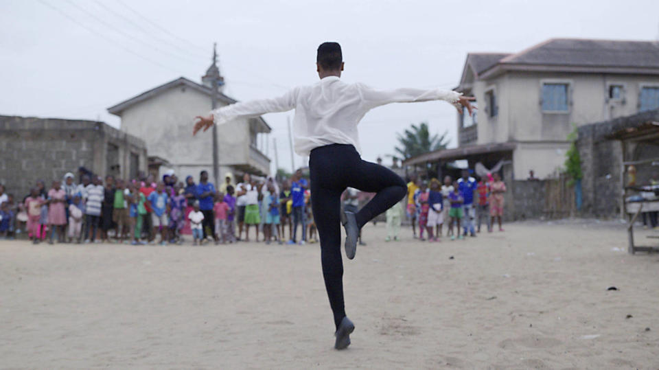 Anthony Madu dancing in the streets of Ajangbadi, Nigeria. (Disney+)