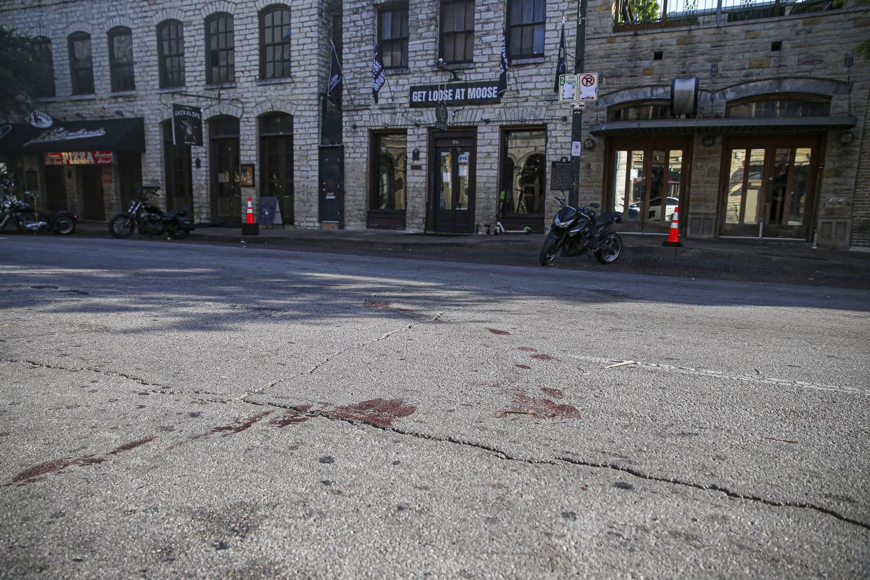 Blood stains remain on 6th Street after an early morning shooting on Saturday, June 12, 2021 in downtown Austin, Texas.