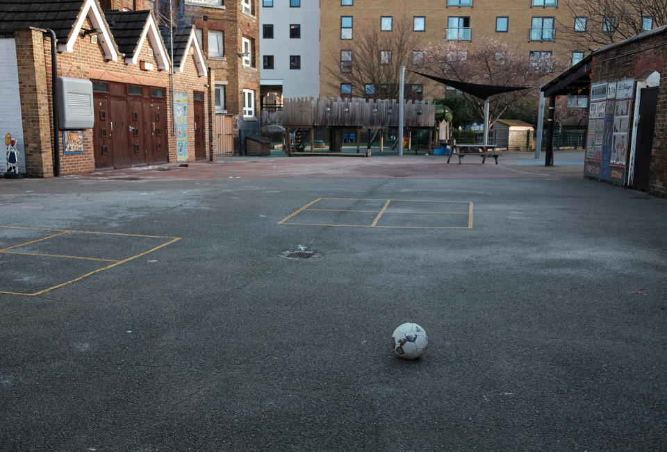 A football lies on the empty playground of a primary school in east London, which has moved into the highest tier of coronavirus restrictions as a result of soaring case rates. (Photo by Yui Mok/PA Images via Getty Images)