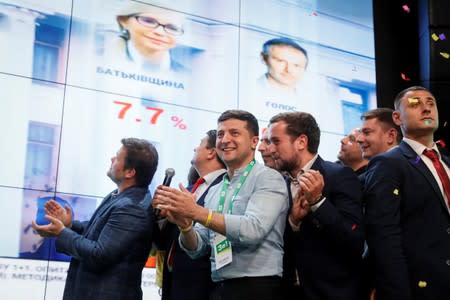 Ukraine's President Volodymyr Zelenskiy reacts at his party's headquarters after a parliamentary election in Kiev