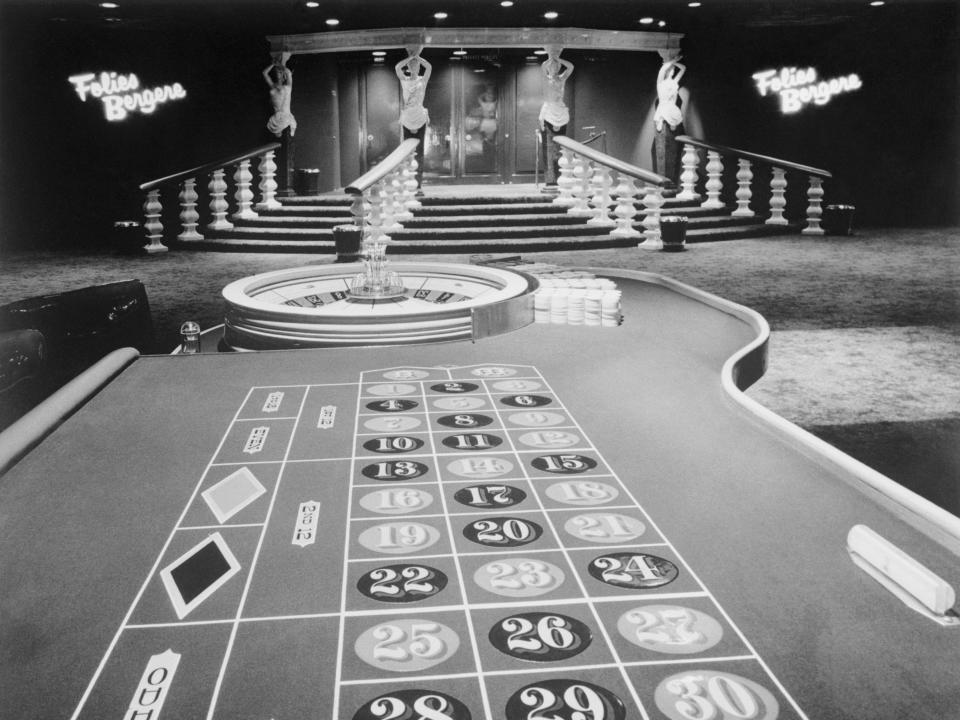 image of gambling table in darkly lit casino room