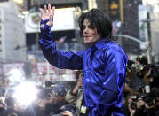 FILE - In this Nov. 7, 2001 file photo, Michael Jackson waves to crowds gathered to see him at his first ever in-store appearance to celebrate his new album "Invincible" in New York. As the 10th anniversary of Jackson’s death approaches, experts say his music legacy is still going strong despite the documentary’s detailed abuse allegations. (AP Photo/Suzanne Plunkett, File)