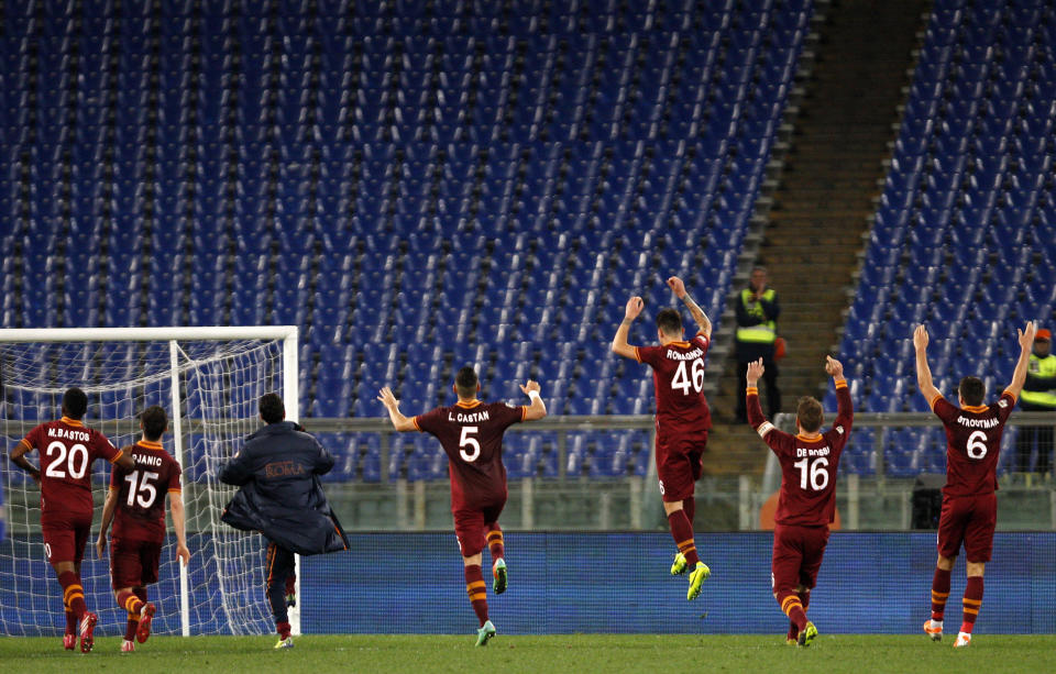 AS Roma players celebrate at the end of a Serie A soccer match between AS Roma and Sampdoria, at Rome's Olympic stadium, Sunday, Feb. 16, 2014. AS Roma won 3-0. (AP Photo/Riccardo De Luca)