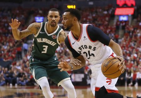 May 21, 2019; Toronto, Ontario, CAN; Toronto Raptors guard Norman Powell (24) dribbles the ball past Milwaukee Bucks guard George Hill (3) during the first half in game four of the Eastern conference finals of the 2019 NBA Playoffs at Scotiabank Arena. Mandatory Credit: John E. Sokolowski-USA TODAY Sports